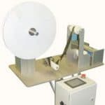 Cut to length station with unwind and roll feed cuts plastic roll of tape