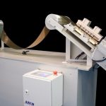 Cut to length station punches and cuts clear plastic in roll form