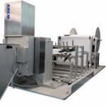 Cut to length system unwinds gauze from roll and pleats, heat seals, and cuts it to length