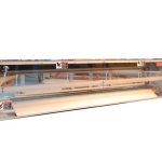 Traveling knife with unwind/rewind, roll feeder and a knife assembly