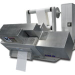 Cut to length with unwind and 45 degree angled baseplate feeds and cuts release liner material