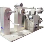 Narrow web slitter rewinder converts rolls of paper material into independent rolls of smaller widths