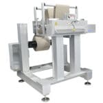 Cut to length station with heavy duty unwind cuts nonwoven material in roll form to size