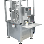 Cut to length station with safety enclosure unwinds and cuts nonwoven material