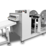 Cut to length sheeter with unwind, feeds, slits, and rewinds multilayered material